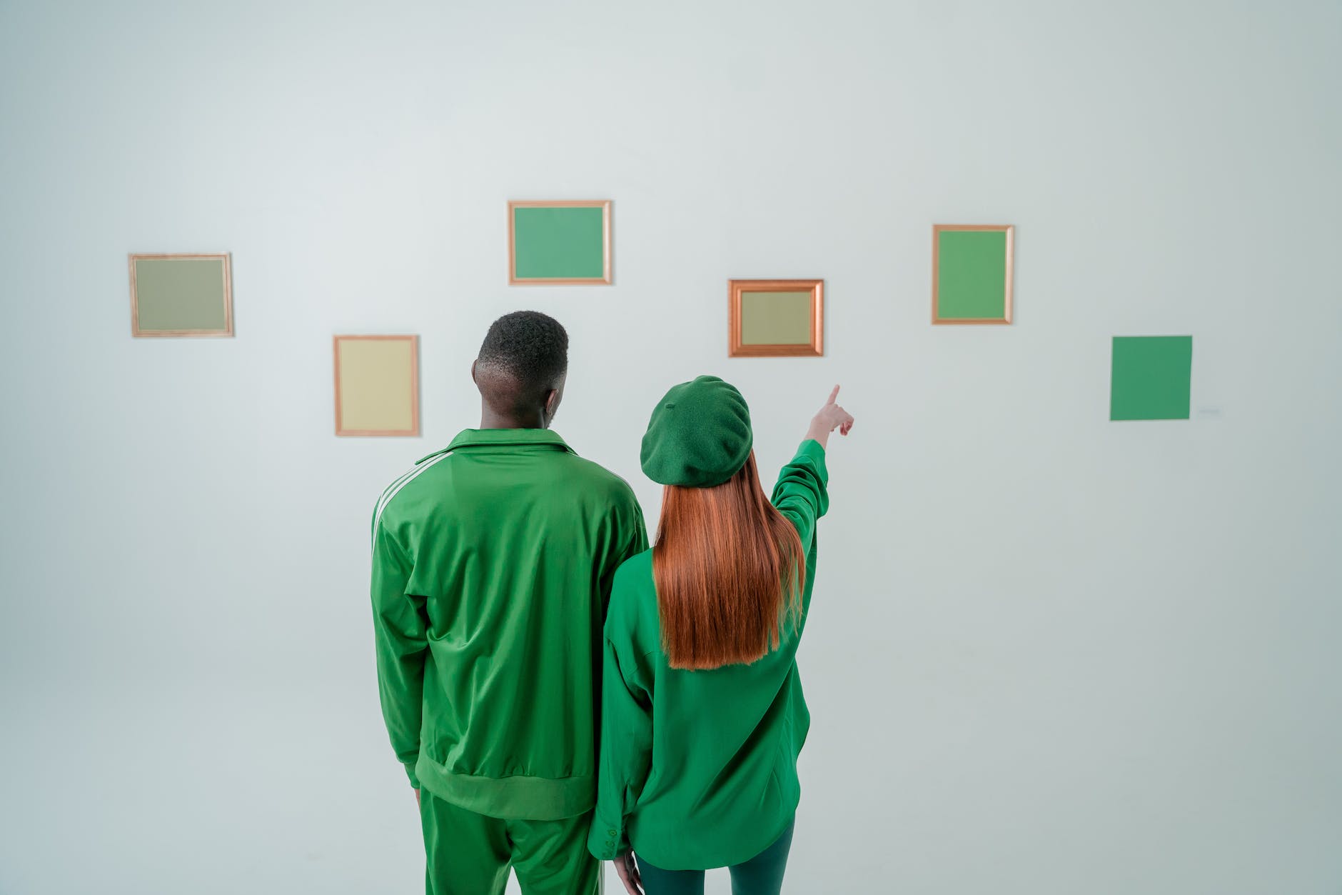 couple wearing green clothes in art gallery